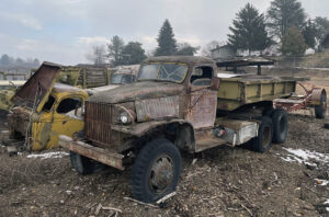 A truck that is sitting in the dirt.