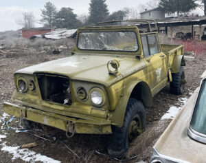A yellow truck is parked in the snow.